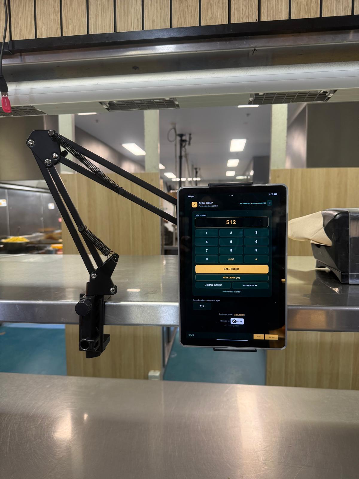 Mounted QRight touchscreen tablet at the kitchen counter with order-number keypad, Call Order and recall controls